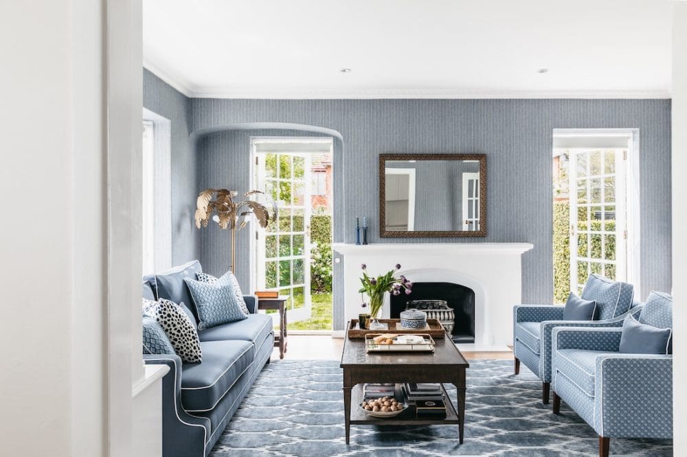 Blue living room with patterned rug at Patterned Sanctuary by The Stylesmiths