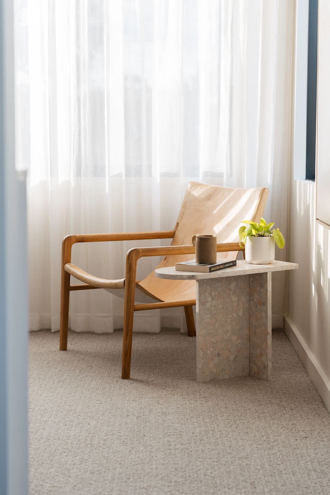 Seating nook with terrazzo side table in minimalist modern bedroom